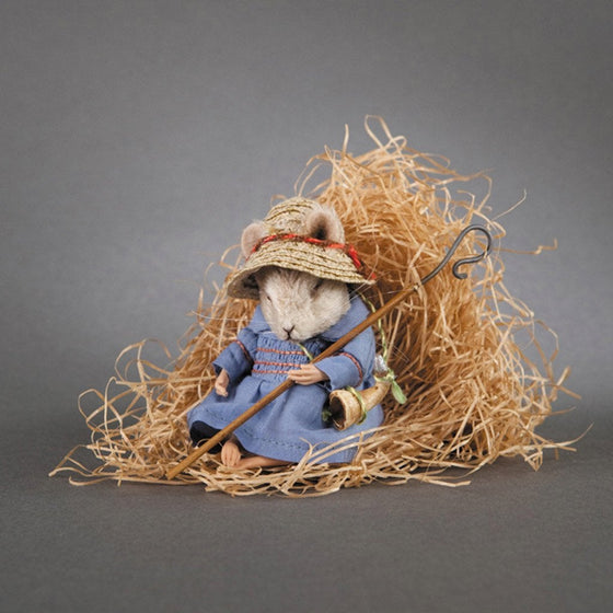 Billy Boy Blue mouse asleep on a pile of hay