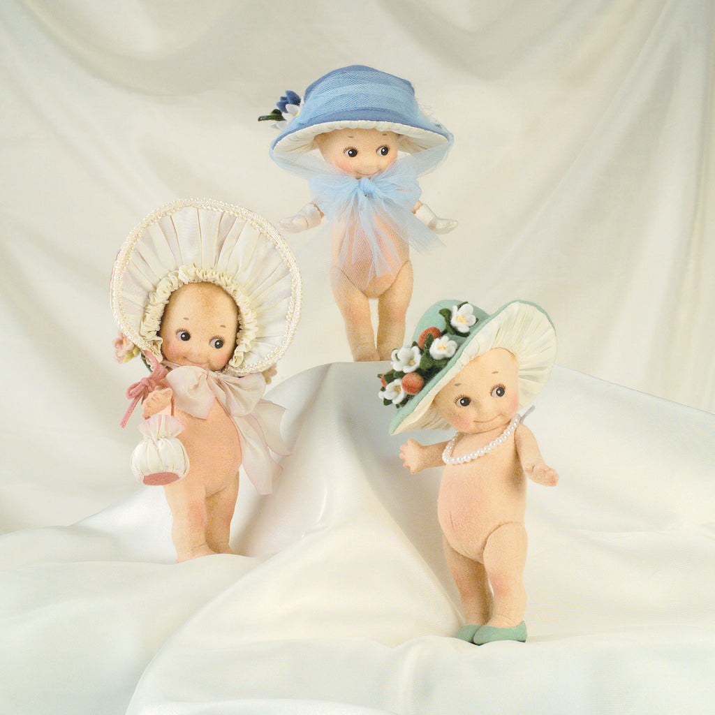 hand crafted felt kewpie dolls wearing easter bonnets