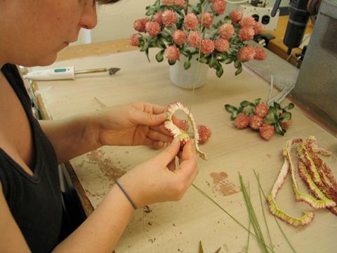 The all-felt clover blossoms are carefully constructed by hand during production